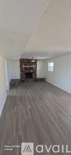 A room with a fireplace and a wooden floor.
