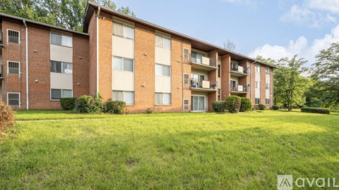 Apartment complex with grassy area in front.