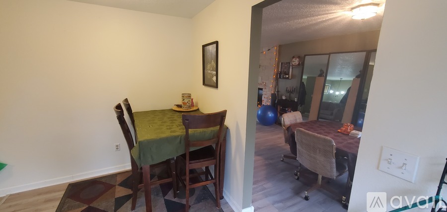 A dining room with a table and chairs is shown.
