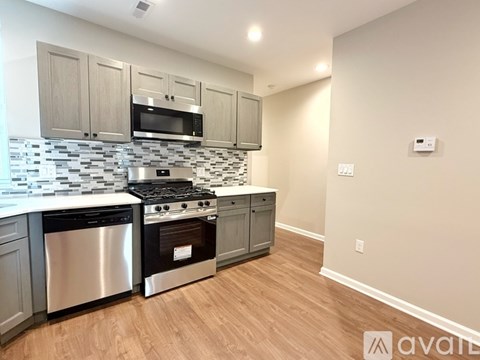 A kitchen with a stainless steel dishwasher and oven.