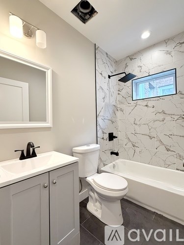 A bathroom with a white toilet and a white sink.