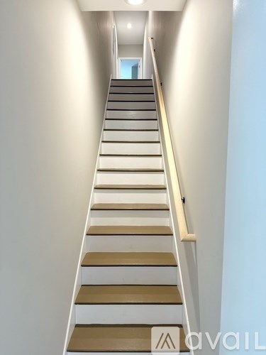 A long staircase with beige and white steps.