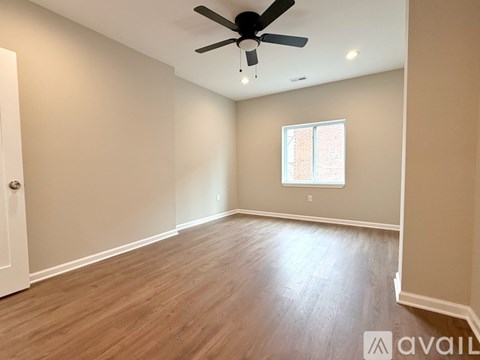 A spacious room with a ceiling fan and a window.