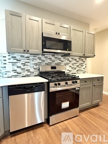 A kitchen with a stove top oven and a microwave above it.