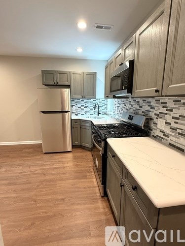 A kitchen with wooden cabinets and a white countertop.