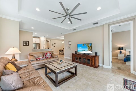 A living room with a brown couch and a coffee table.