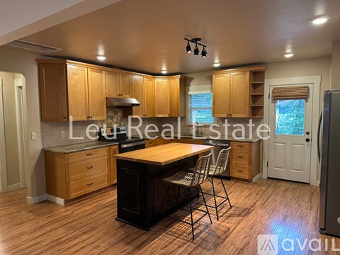 A kitchen with wooden cabinets and a central island.