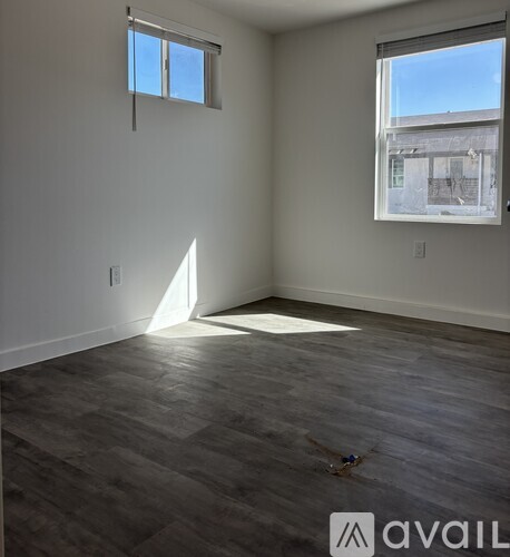 A room with a large window and a view of a building outside.