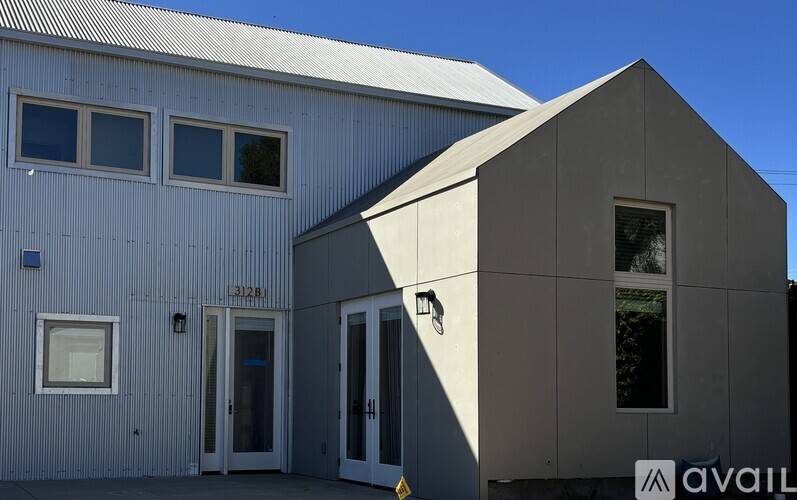 A drawing of a modern house with a grey exterior and wooden accents.