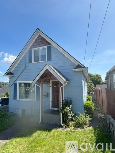 A small house with a front porch and a brown door.