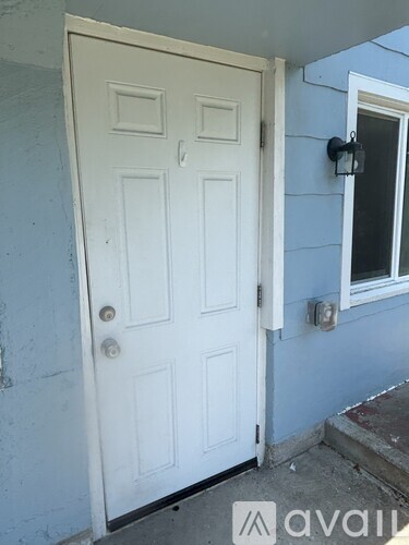 A white door with a window to the right.