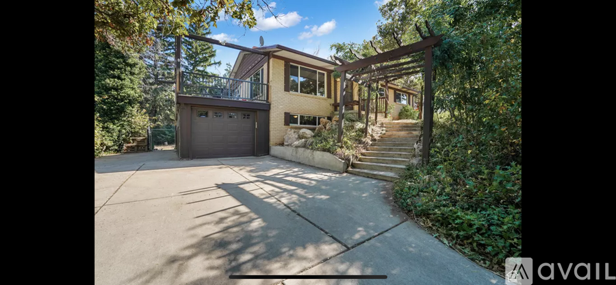 A house with a driveway and a garage is for sale.