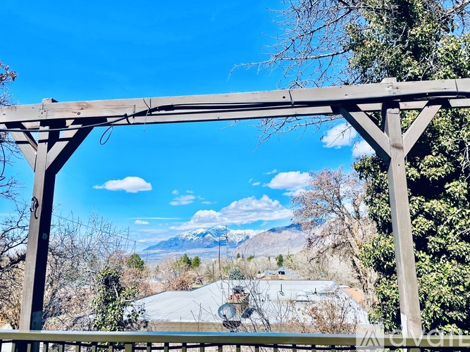 A wooden structure with a mountain range in the background.
