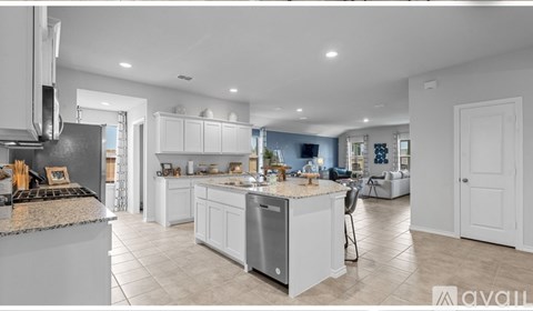 A modern kitchen with white cabinets and a central island.