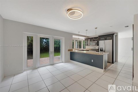 A kitchen with a counter and cabinets is available for rent.