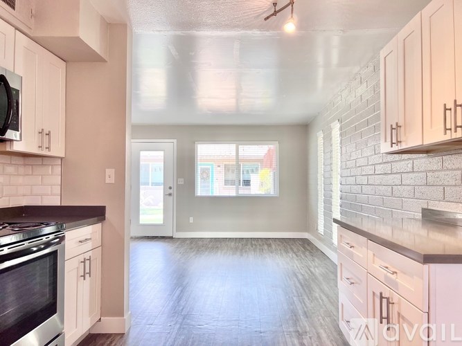 A kitchen with a stove top oven and a microwave.