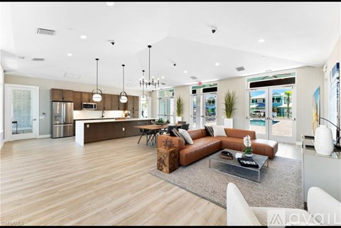 A modern living room with a brown sofa and a glass coffee table.