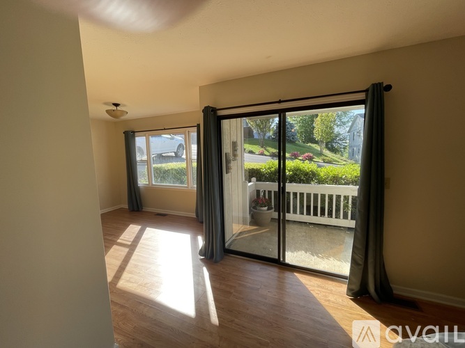 A room with a sliding glass door leading to a balcony.
