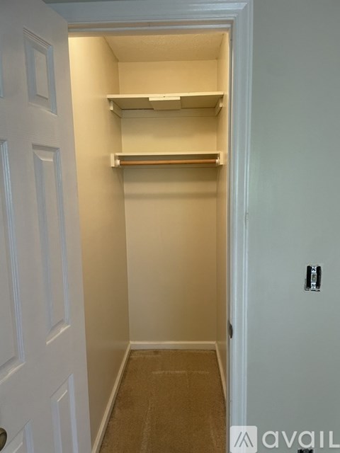A white door with a shelf above it.