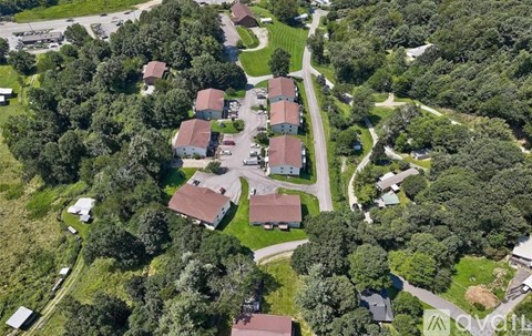 A bird's eye view of a residential area with houses and trees.