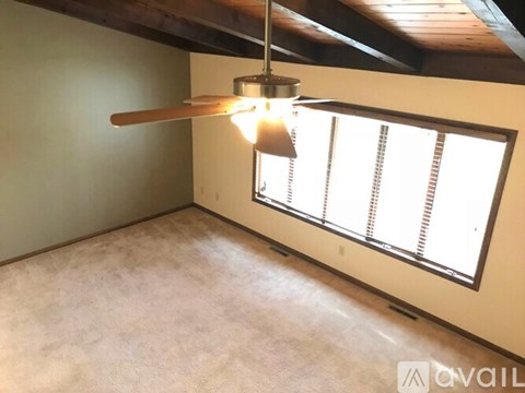 A room with a window and a light fixture.