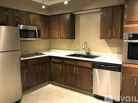 A kitchen with wooden cabinets and stainless steel appliances.