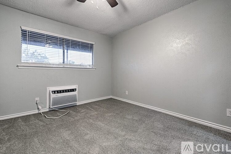 A room with a window and a wall-mounted heater.