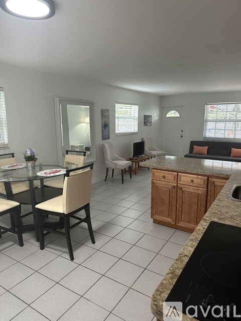 A kitchen with a table and chairs.