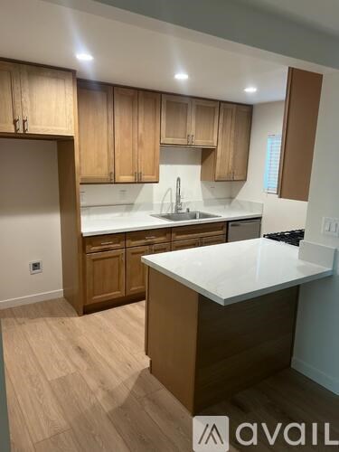 A kitchen with wooden cabinets and a white countertop.