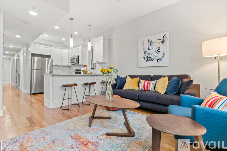 A modern living room with a blue couch and a wooden coffee table.