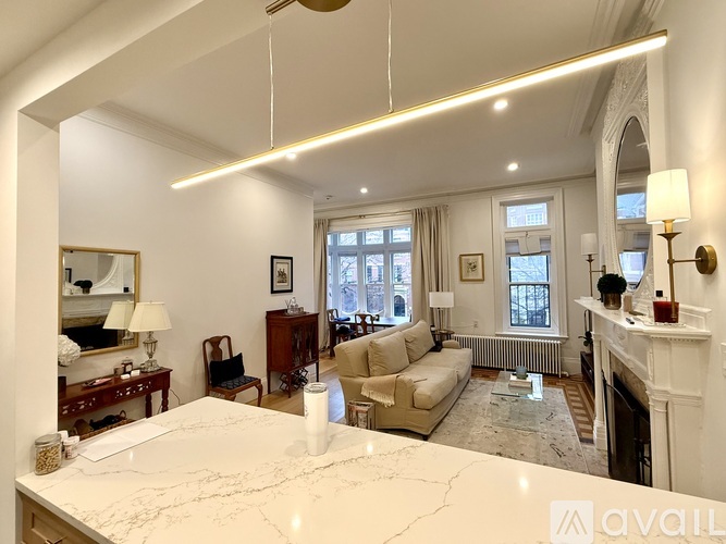A spacious room with a fireplace and a mirror on the wall.