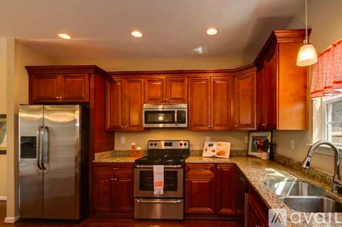A kitchen with wooden cabinets and stainless steel appliances.