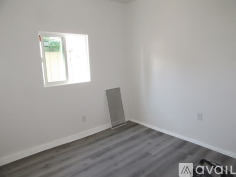 A kitchen with white cabinets and a sink.