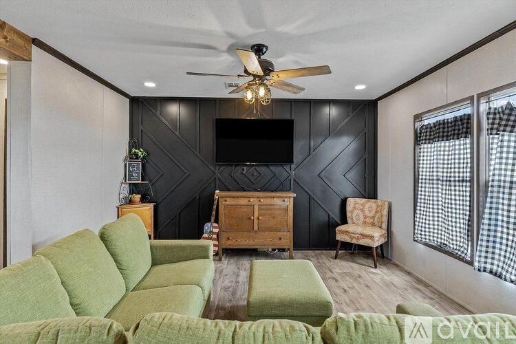A living room with a green sofa and a wooden chest.