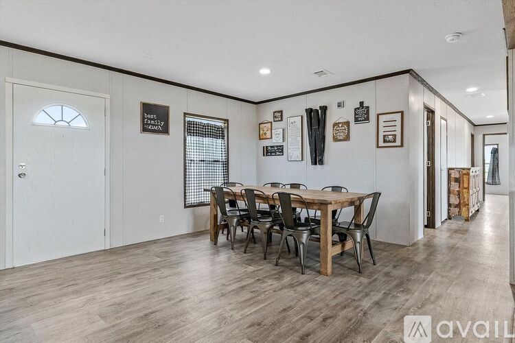 A dining room with a wooden table and chairs.