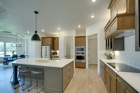 A modern kitchen with wooden cabinets and a large island.