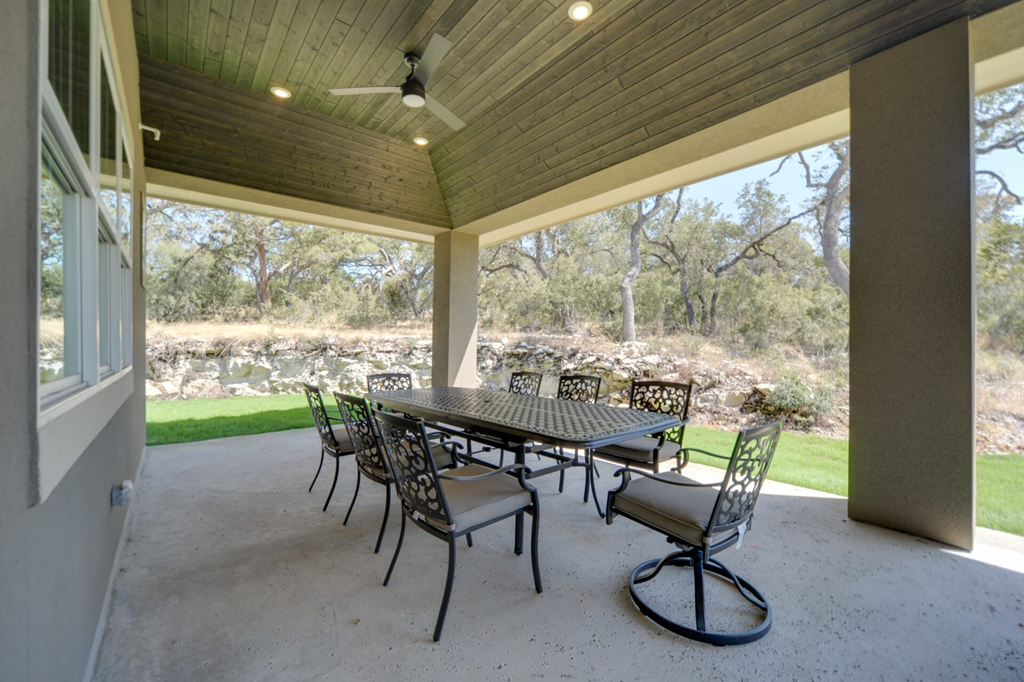 A patio with a table and chairs.