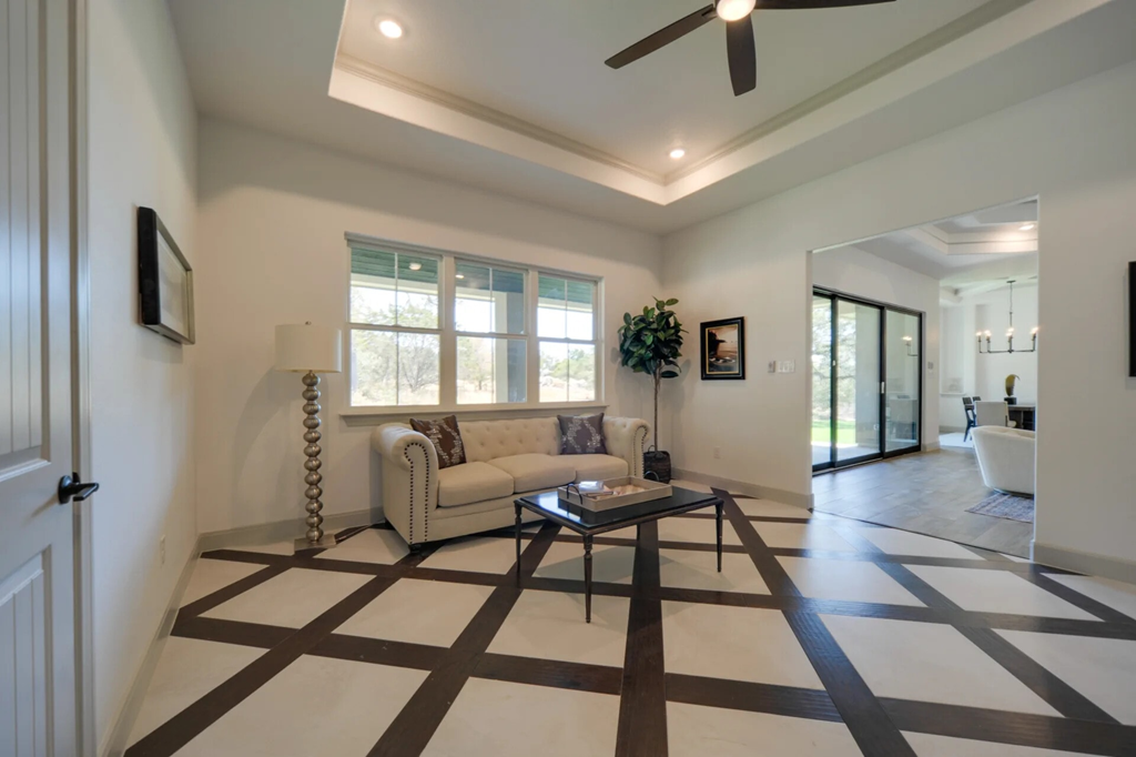 A living room with a white couch and a coffee table.