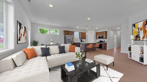 A modern living room with a white couch and a black coffee table.