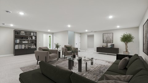 A modern living room with a dark green sofa and a coffee table.