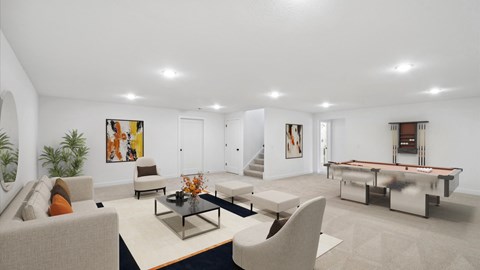 A living room with a pool table and a couch.