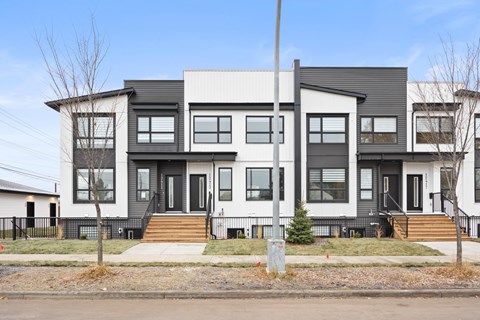 A modern two-story house with a black and white exterior.