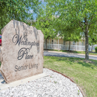 A stone sign that says Wedington Place Senior Living.