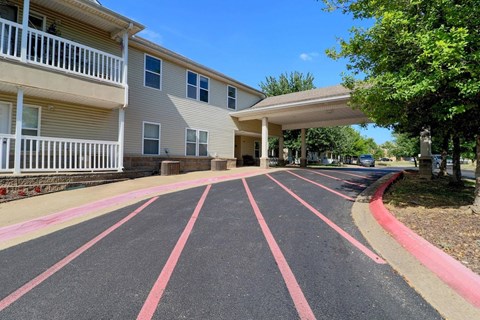 A parking lot with red stripes in front of a building.