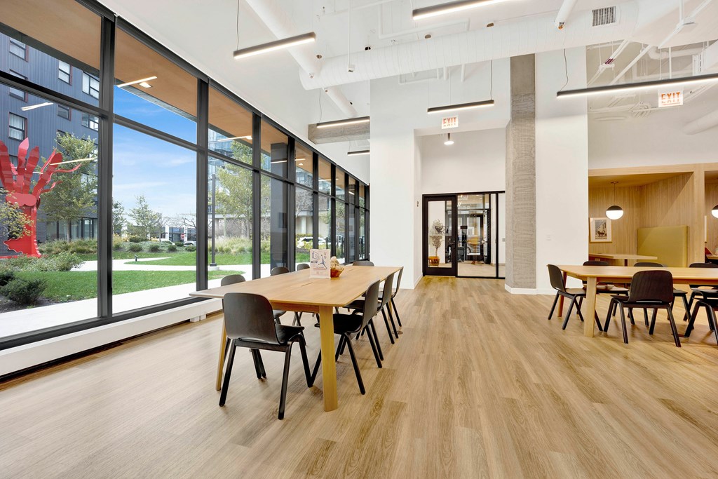 A conference room with a long table and chairs.
