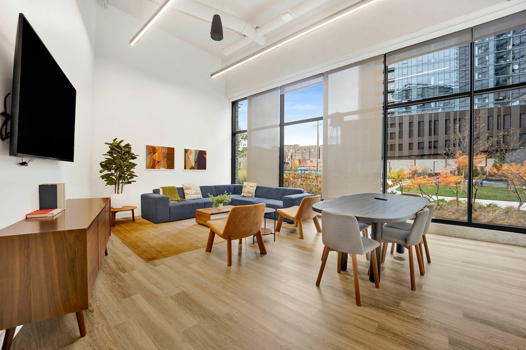 A living room with a television, couches, and a table.