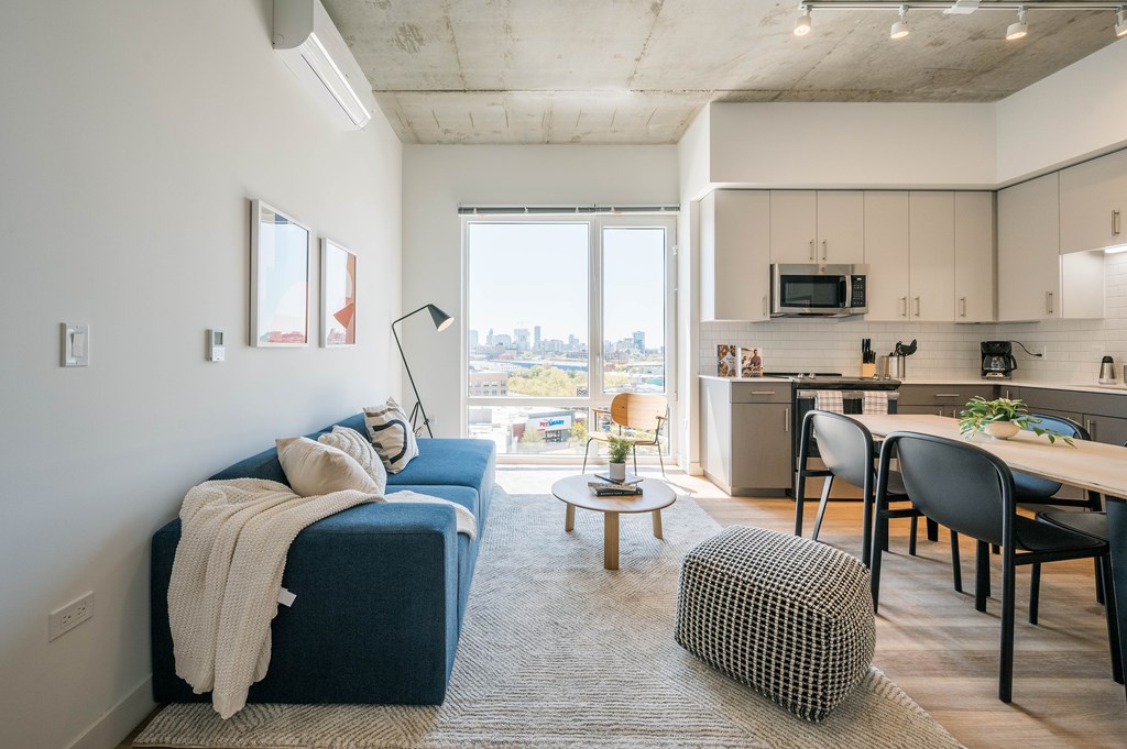 A modern living room with a large window overlooking the city.