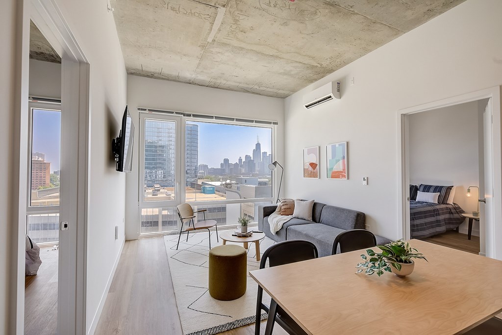 A living room with a view of the city skyline.