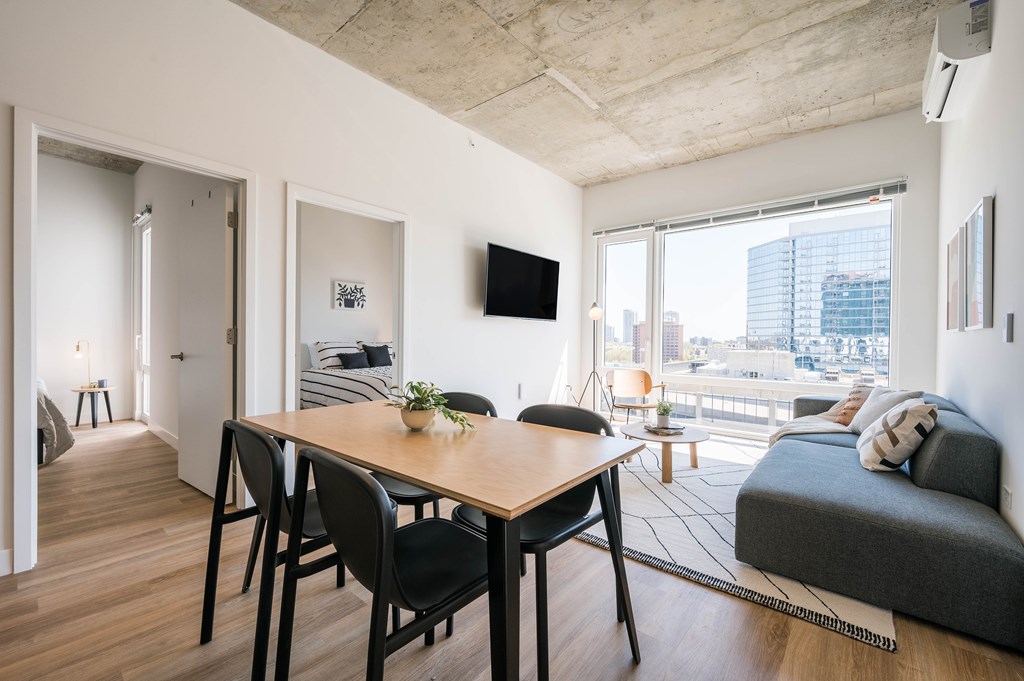 A modern living room with a dining table and a couch.