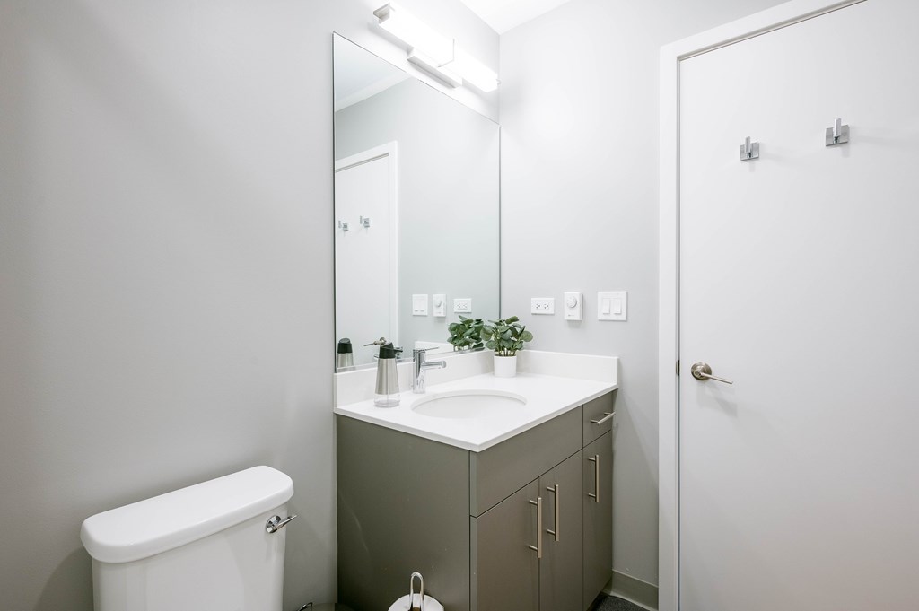 A white toilet sits next to a sink in a bathroom.